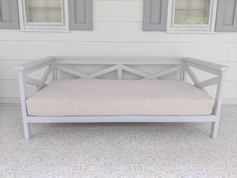 light gray daybed with twin mattress with linen cover.