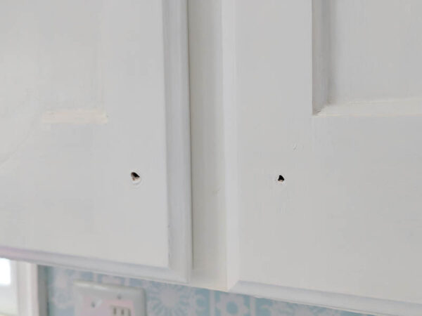 close up of fresh white paint on cabinet doors after touching up the chipped paint