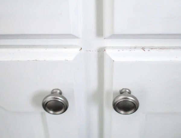 close up of small paint chips on painted cabinets