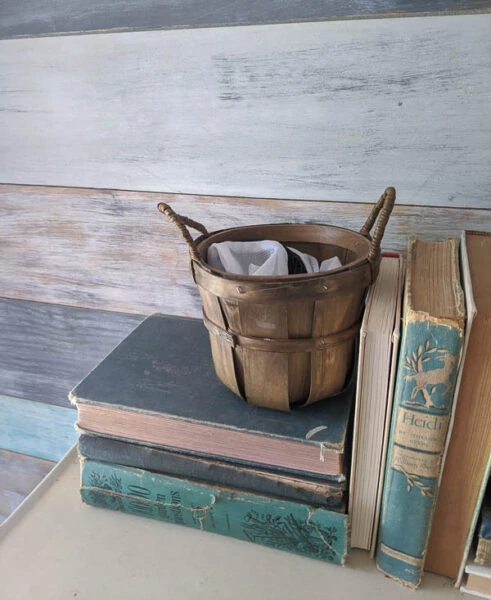 basket on table in entryway for used face masks