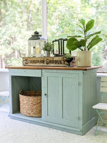 old blue cabinet painted with blue milk paint on the screened in porch