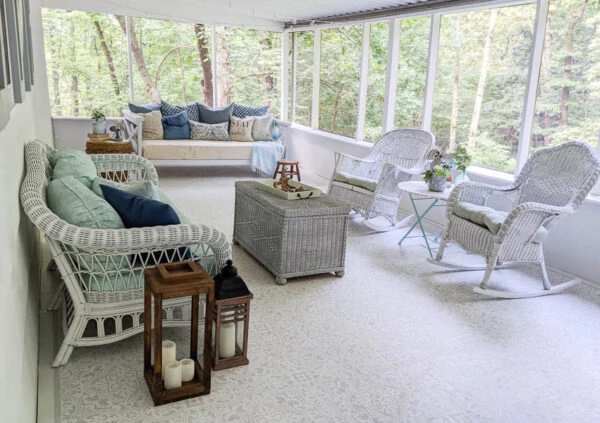 light, bright screened-in porch with gray and white stenciled floor and white walls