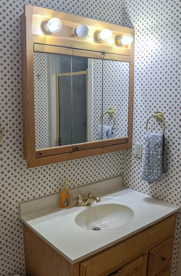 ask bathroom vanity and matching oak medicine cabinet with attached vanity light
