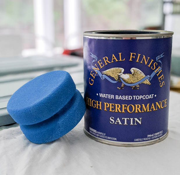 This dynamic duo is the perfect pairing for getting a durable, perfectly smooth finish on painted furniture and cabinets. a can of General Finishes High Performance Top Coat and the blue sponge applicator from Dixie Belle paint