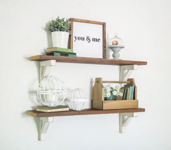 Reclaimed wood shelves with diy white shelf brackets styled with farmhouse decor.