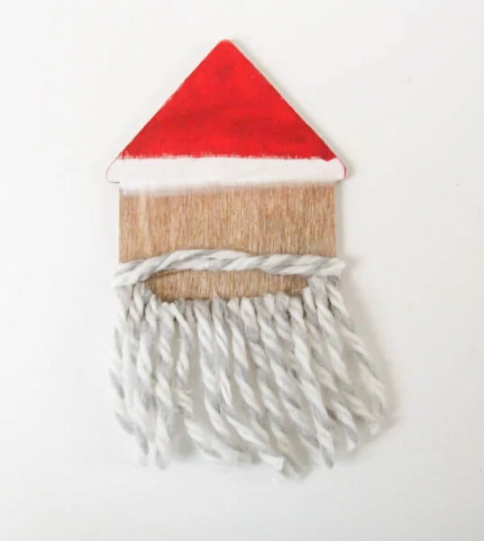 santa ornament with yarn mustache and beard.