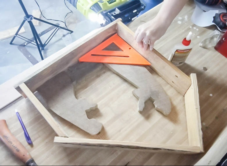 Constructing the wood nativity stable using a nail gun.