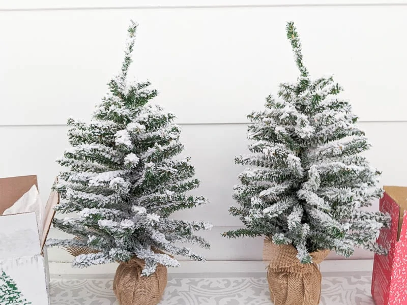 Two mini flocked Christmas trees flocked with two different flocking powders.