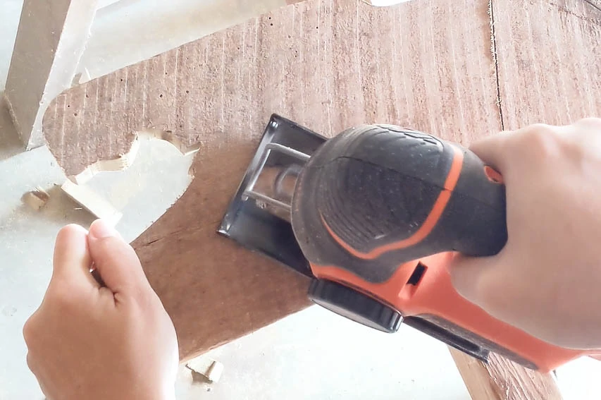 overhead view of jigsaw cutting out Mary figure for DIY nativity.