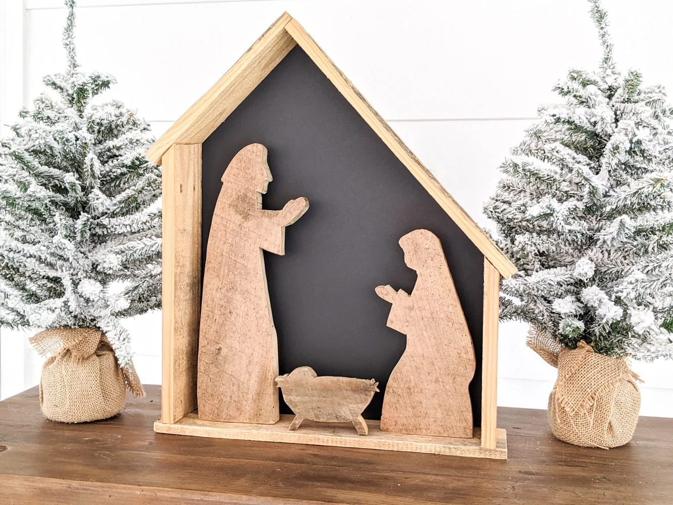 Diy wood nativity with black backing.