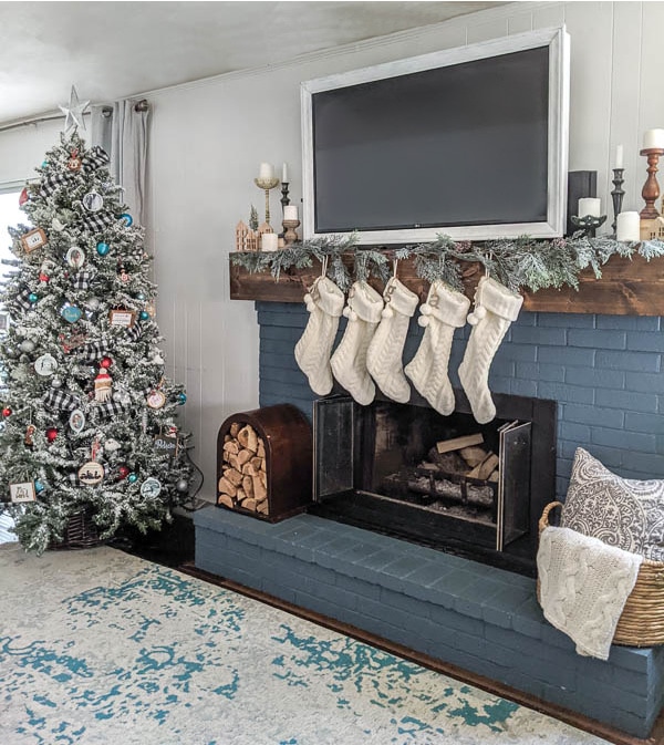 dark blue fireplace with white stockings and garland