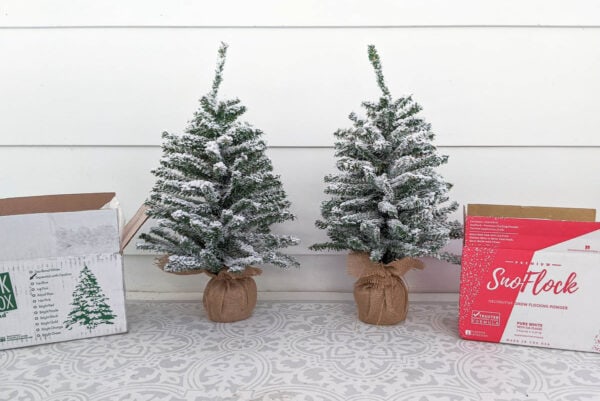 two small Christmas trees flocked with SnoFlock and Flock in a Box snow flocking powder.