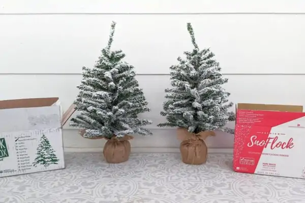 two small Christmas trees flocked with SnoFlock and Flock in a Box snow flocking powder.