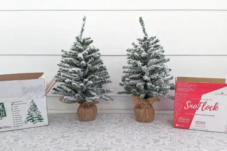 two small Christmas trees flocked with SnoFlock and Flock in a Box snow flocking powder.