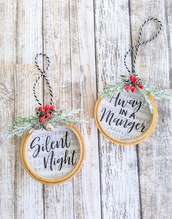 diy embroidery hoop ornaments with the songs Silent Night and Away in a Manger on them.