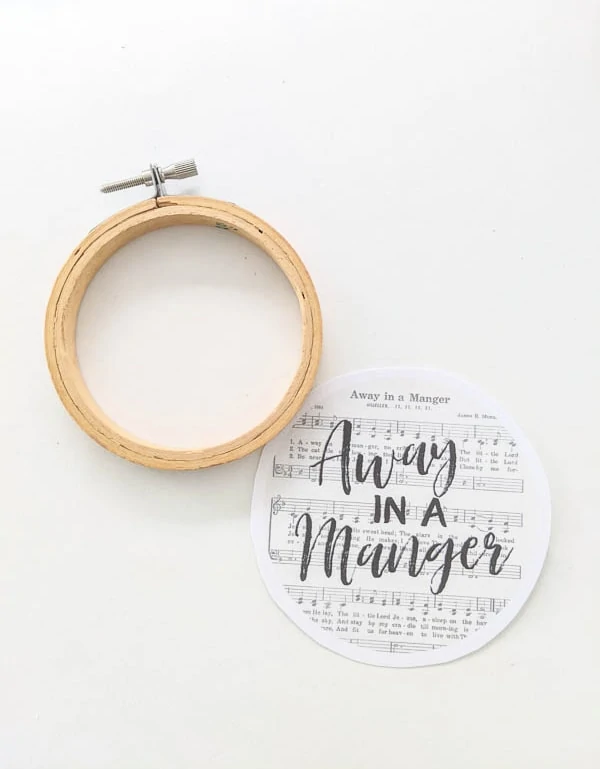 mini embroidery hoop next to Away in a Manger printable ornament design.