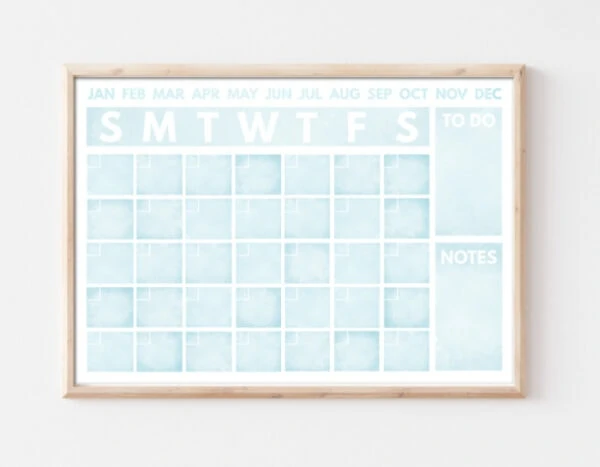 light blue watercolor calendar framed and hanging on wall.
