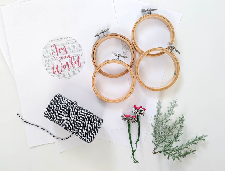 materials for ornaments - printable designs, embroidery hoops, mini pinecones, mini branches, bakers twine.