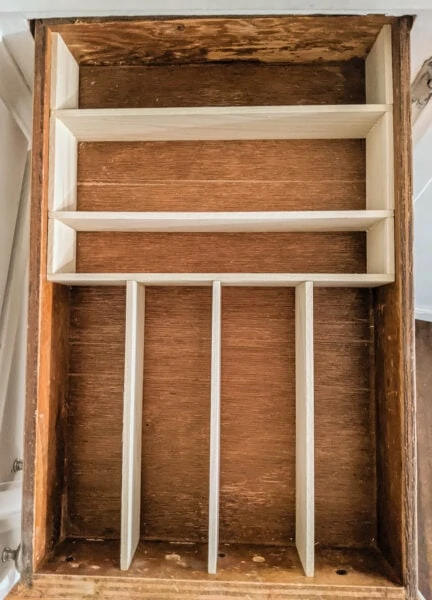 Empty silverware drawer with wood drawer dividers in place.