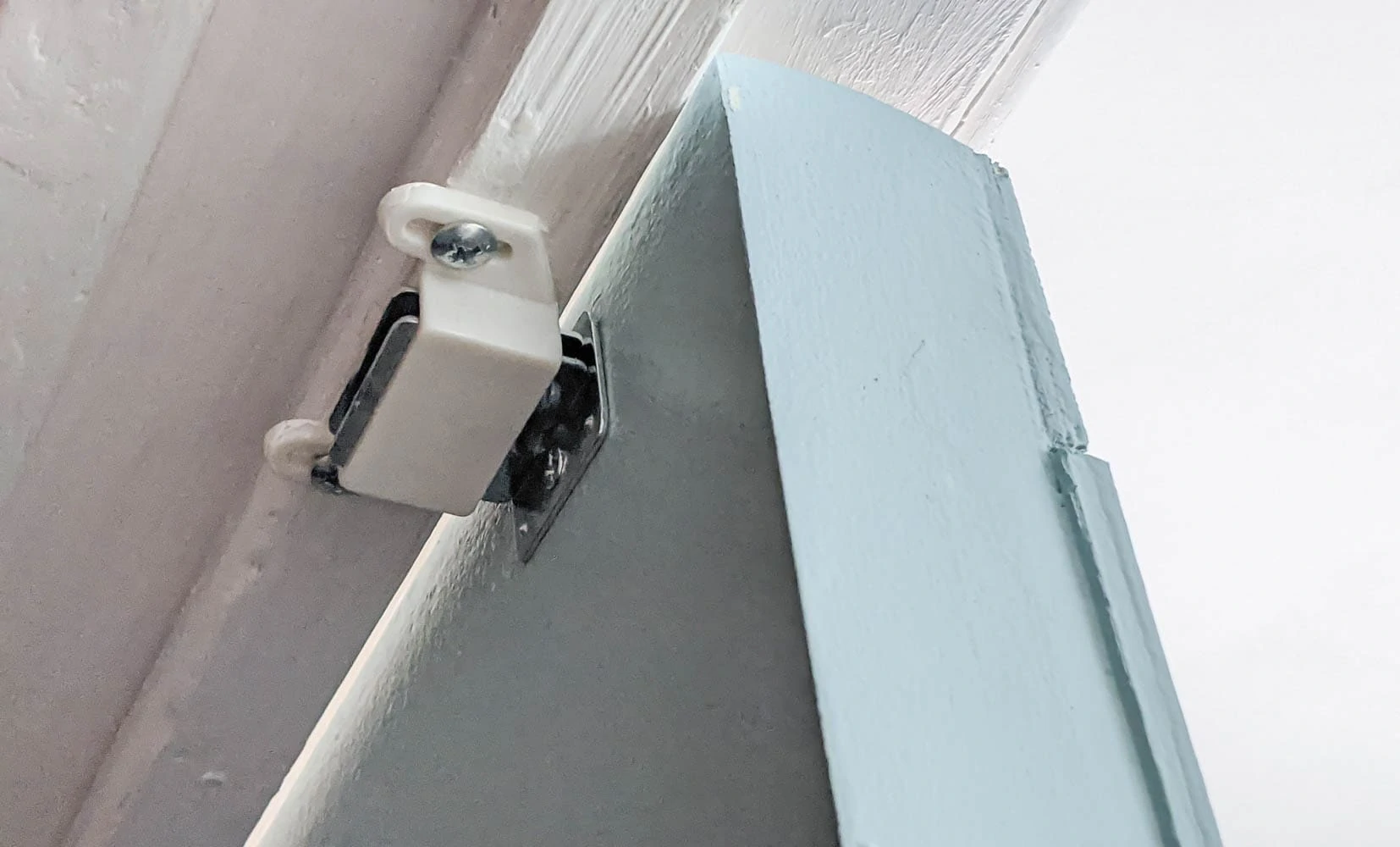 magnetic catch at top of closet doors.