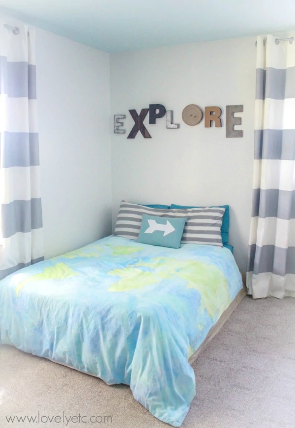 painted world map duvet cover in little boys bedroom.