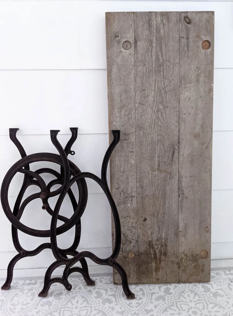 old legs from a vintage sewing machine and the old wood top from a bench.