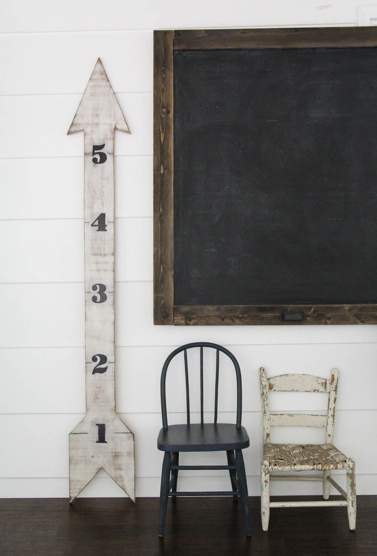 weathered white growth chart with black numbers.