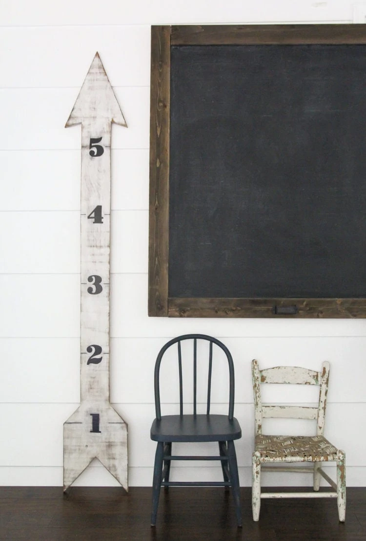 huge diy wood chalkboard, diy wooden arrow growth chart, and vintage children's chairs.