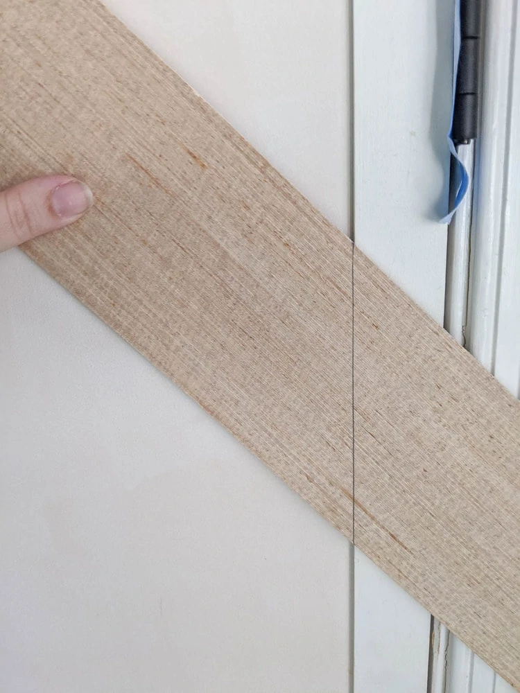 marking where to cut the second end of the wood strips.