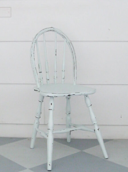 antique child's chair painted light blue and distressed.