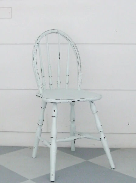 antique child's chair painted light blue and distressed.