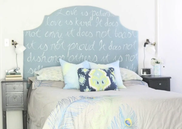 bed with diy pillow covers and diy painted upholstered headboard.