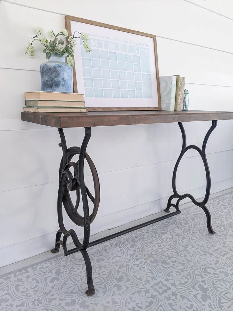old cast iron sewing machine table legs repurposed to make a small table with an upcycled wooden top.