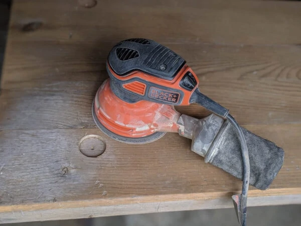 sanding down an old wood finish.