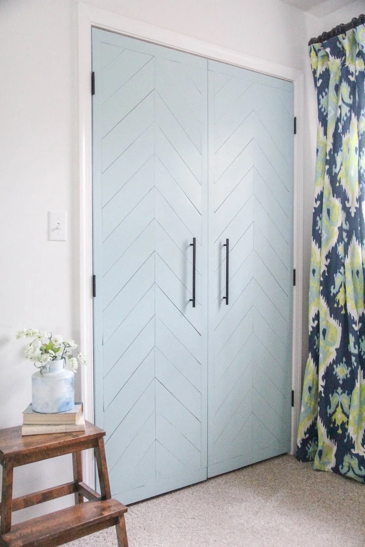 Closet doors  updated with thin plywood laid in a chevron pattern and painted. 