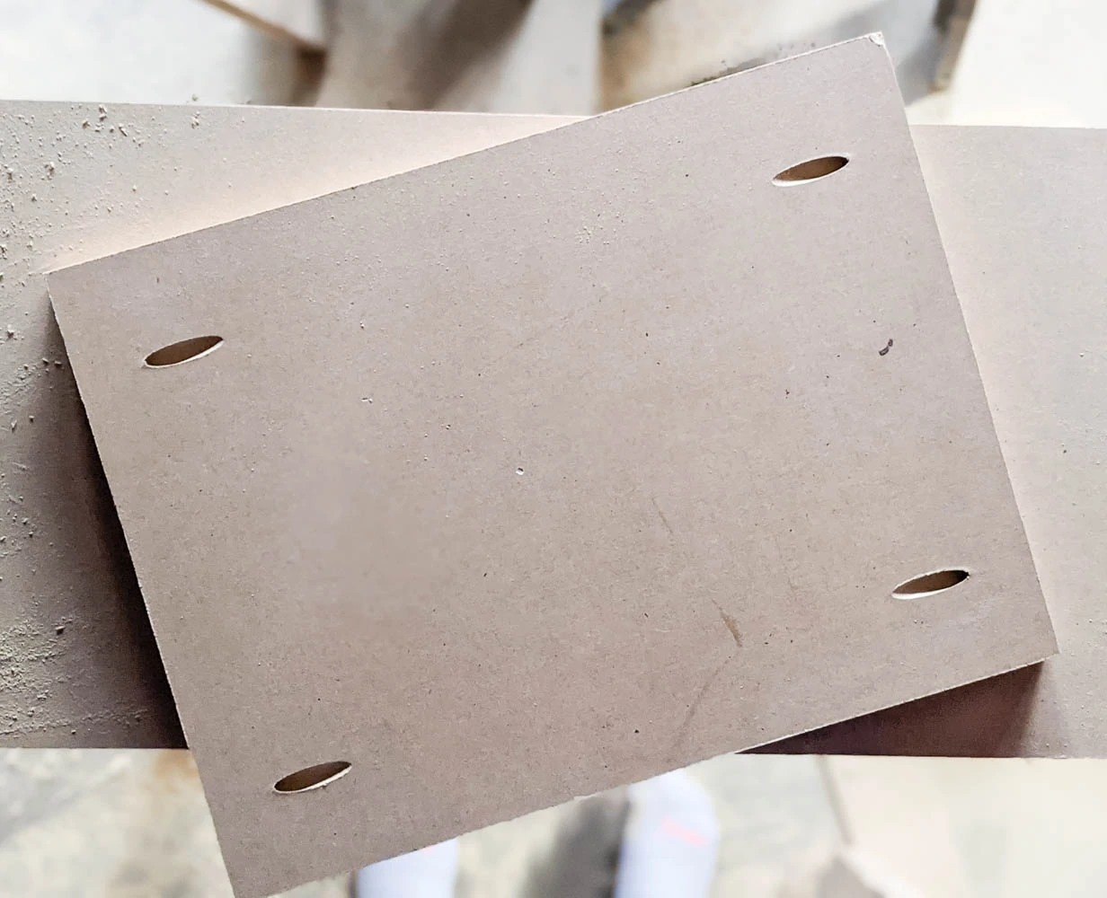 Bottom of MDF shelf with four pocket holes, two on each short side.