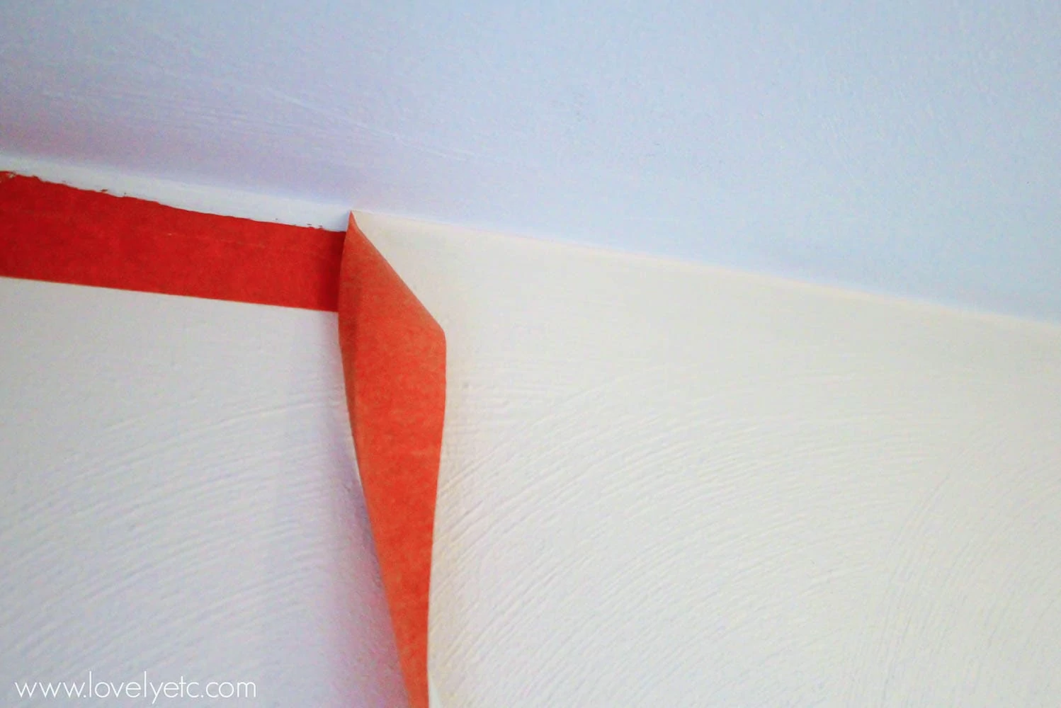 pulling painter's tape down after painting ceiling.