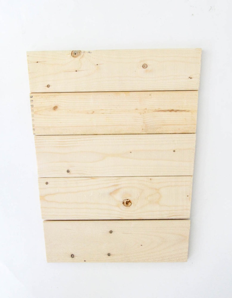 wood slats cut at an angle to make a tapered planter box.