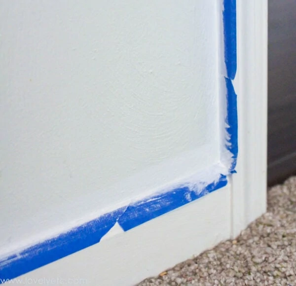 sealing over painters tape with the same color as the adjoining trim to keep any dark paint from slipping underneath and ruining the finish.