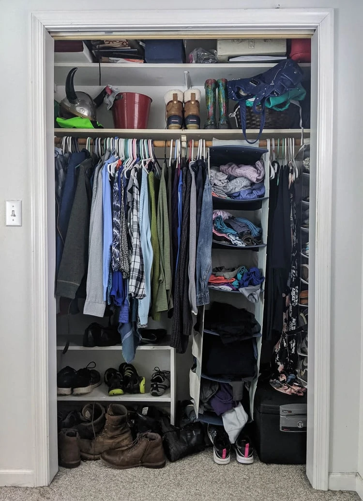 messy small closet before adding a closet organizer