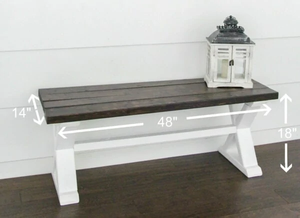 diy wood bench with a dark wood top and white x legs with dimensions marked.