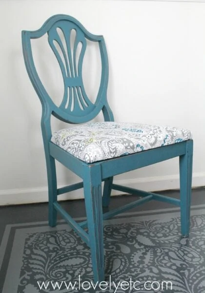 Wooden dining chair painted blue and reupholstered using fabric from a shower curtain.