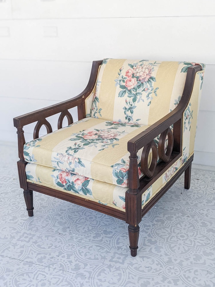 Vintage chairs before reupholstery with dark wood arms and yellow striped floral fabric.