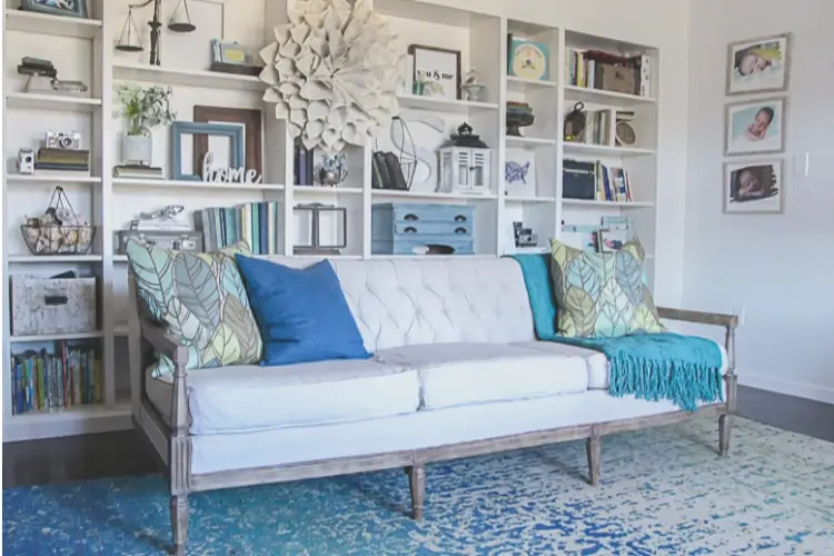 vintage sofa upholstered with drop cloth in front of bookcase