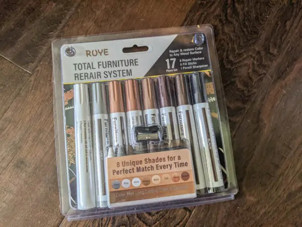 Wood repair kit with wood markers and wax fill sticks.
