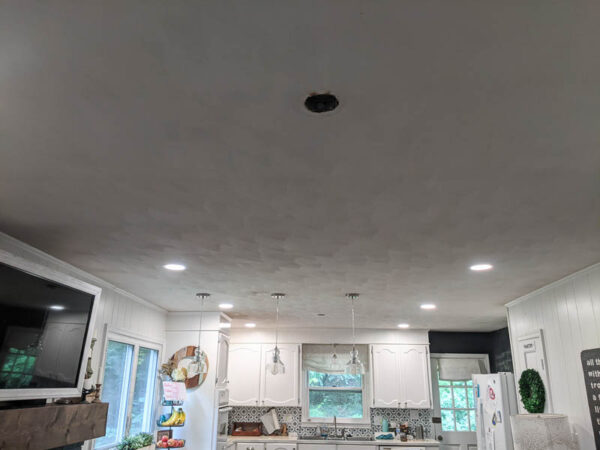 living room ceiling with hole from old light fixture.