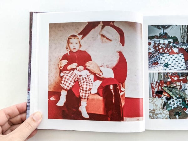 photo book open to old fashioned photo of toddler on Santa's lap.