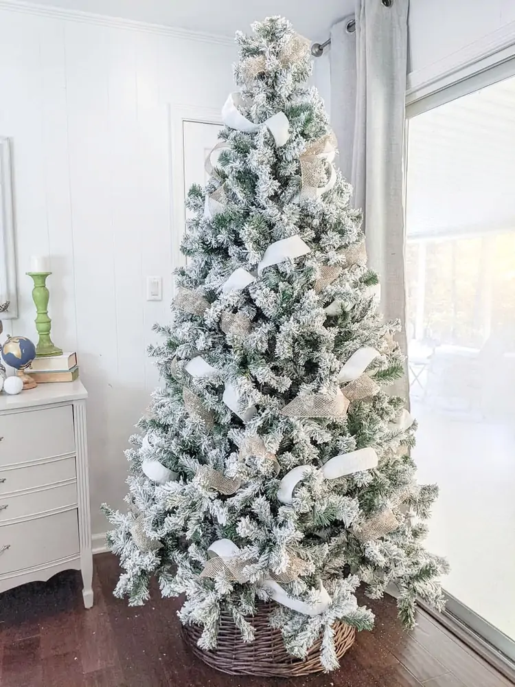 Christmas tree with gold and white ribbon woven throughout.