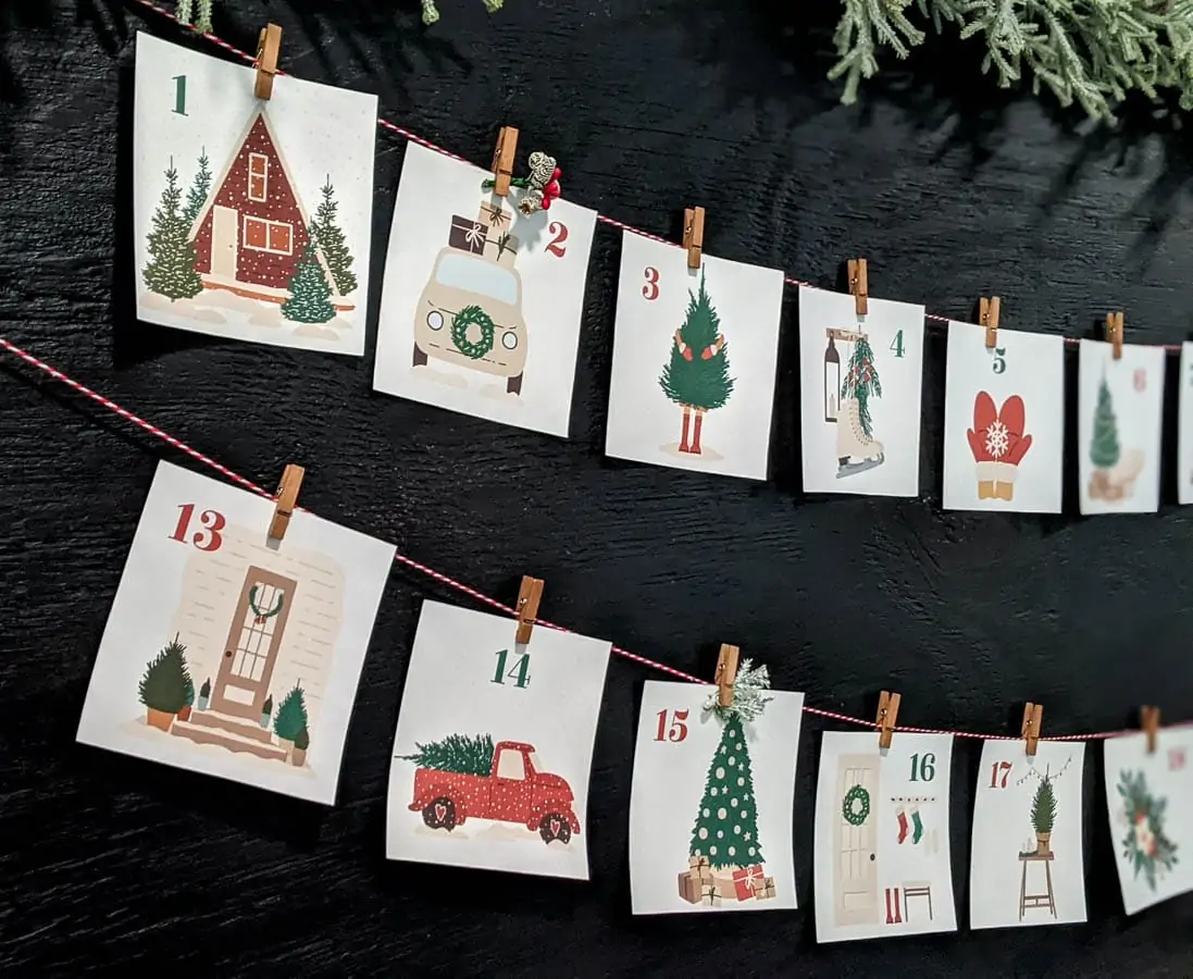 closer view of paper advent calendar cards hanging from twine and clothespins.