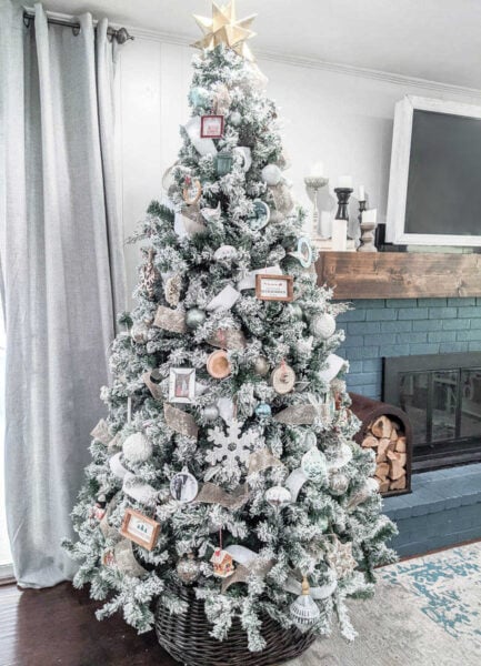 Fully decorated Christmas tree with white and gold ornaments.